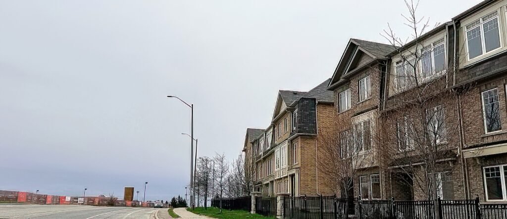 Brampton freehold townhouse backing onto a green park, sunny spring day, no rear neighbours visible