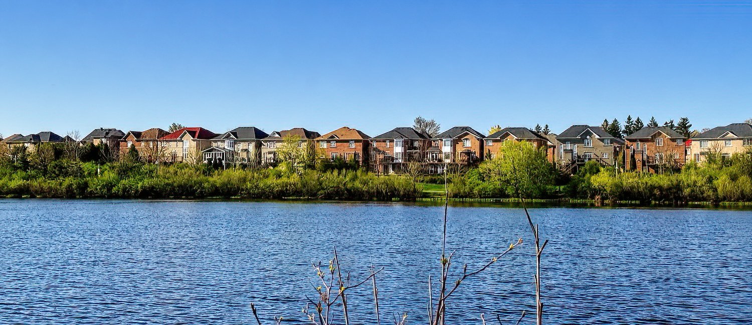 Mississauga couple reviewing selling costs and net proceeds table with real estate agent at kitchen