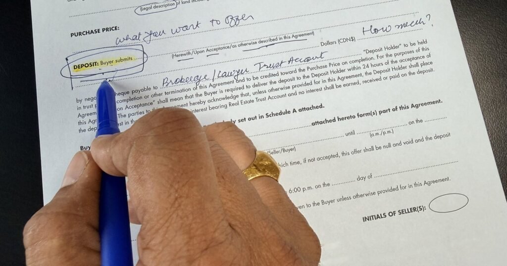 Broker pointing to the deposit clause on an Ontario Agreement of Purchase and Sale during a buyer consultation